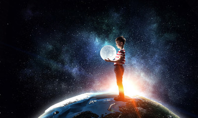 Obraz na płótnie Canvas Boy holds the moon . Mixed media