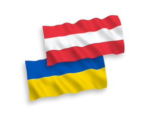 National vector fabric wave flags of Austria and Ukraine isolated on white background. 1 to 2 proportion.