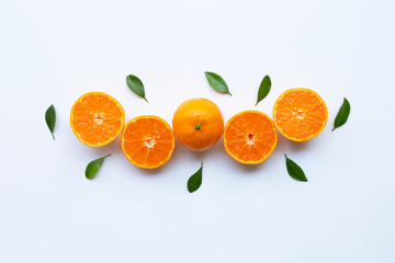 Orange fruits and green leaves on a white background.