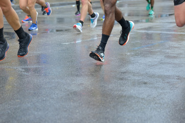 Marathon running race, many runners feet on road racing, sport competition, fitness and healthy lifestyle concept