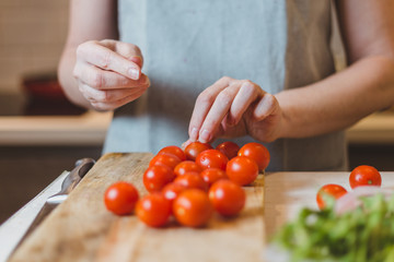 The cook chooses the best tomatoes for quality dishes and exclusive cuisine