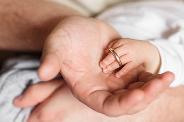 Fototapeta premium Father hands and Baby Newborn hands Love Emotional Family.Parent holding in the hands of newborn baby.Vintage tone