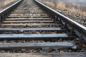Detail of railway tracks with girder and gravel. Shallow DOF