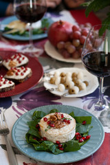 Healthy nutritious lunch or dinner for two: grilled camembert grenade grains. a string of rosemary and nuts 