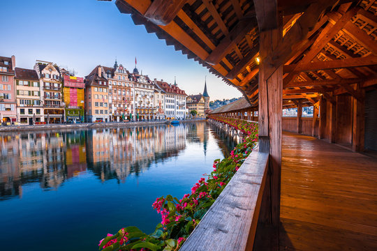 Kapellbrucke historic wooden bridge in Luzern and waterfront landmarks dawn view