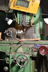 Spindle chuck and installed metal part in pocessing on high precision Cnc industrial lathe turning machine. CNC machine cuts off excess edges on metal part