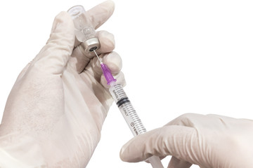 Doctor hand holding vials medication and injection needle isolated on white background. Medical...