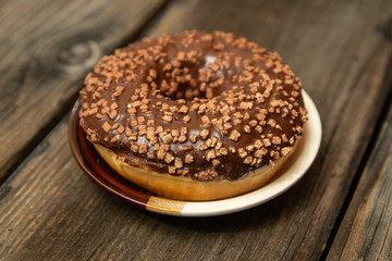 Homemade donuts with chocolate fill and nuts on old wooden table