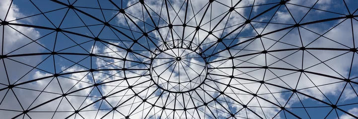 Foto op Plexiglas Bottom view of an iron structure with blue sky and clouds in the background © kelifamily