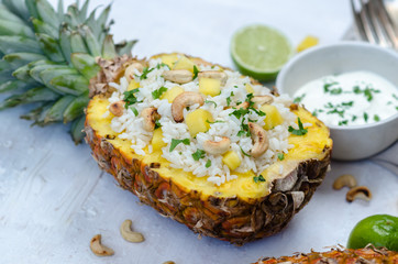 Homemade rice with cashew in pineapple.