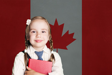 Canada concept with happy child girl in school uniform with book against the Canadian flag background