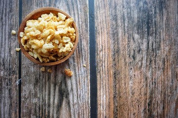 Close up of dried rice snack on wooden bowl. 