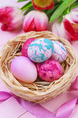 Fototapeta na wymiar Beautiful Easter composition with decorated eggs and flowers on pastel wooden background