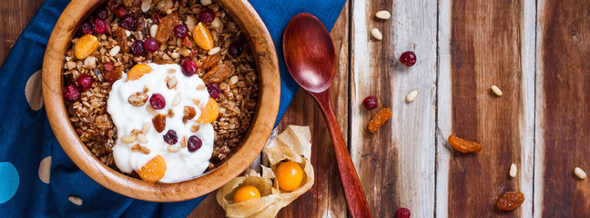 Homemade granola with nuts, cranberries and yogurt.