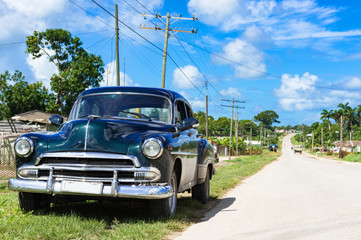 Amerikanischer Oldtimer parkt im Landesinneren am Strassenrand in der Provinz Santa Clara in Cuba - Serie Kuba Reportage