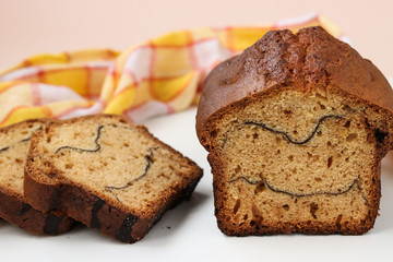 Cheesecake with cocoa located on a white background. On the cut of the cake strips of cocoa