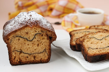 Cheesecake with cocoa located on a white background. On the cut of the cake strips of cocoa