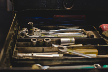 A toolbox tray filled with random and craft tools in the old workshop. 