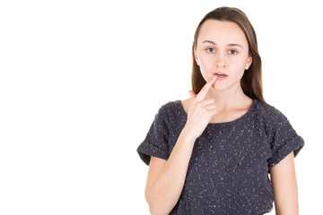 surprised young girl touching her chin on white background with copy space for text