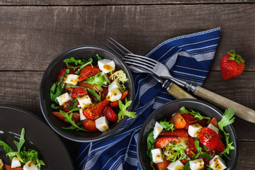 Vegetarian salad with strawberry, tofu and aragula overhead shot