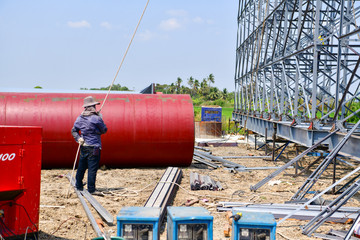 The construction for a billboard made of a large high rise billboard on a super highway in THAILAND telephoto close up on construction detail.