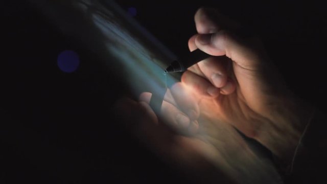 Creative Digital artist edit his artwork on interactive tablet computer at night home office