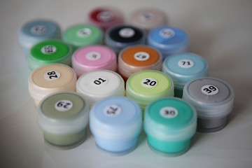 Different capsules jars with paint with number for easier painting for newbies