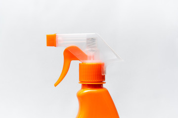 orange spray bottle close up on light background