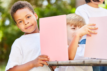 Boy in kindergarten tinkers with cardboard
