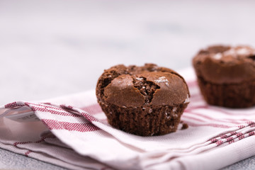 Tasty chocolate muffins on the blue towel