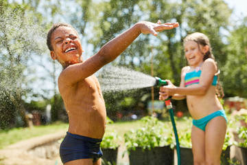 Two children are spattering with water