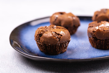 Tasty chocolate muffins on the blue plate