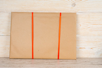 gift with red ribbons on vintage wooden table