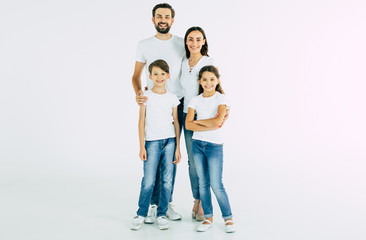 Happy and cheerful young beautiful family are smiling and posing while have a fun together over...