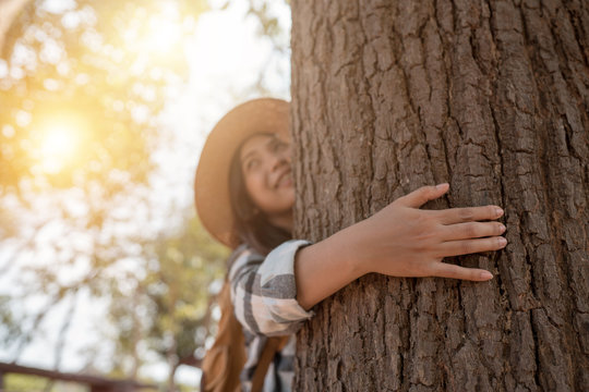 Young female hugging the tree huge in national park lifestyle hipster person