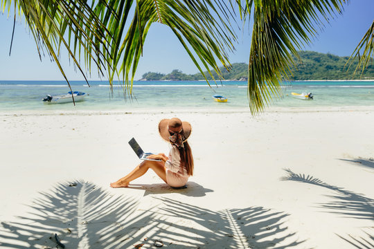 Woman freelancer on the beach