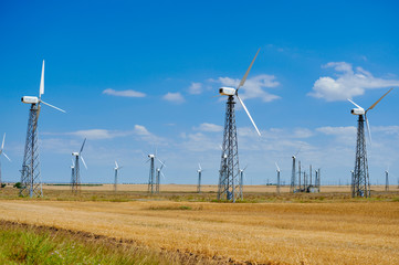yellow steppe with wind turbines producing electricity