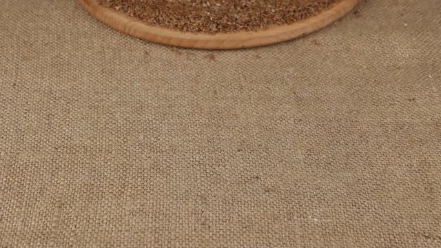 Bottles with flaxseed oil  and linseed on the background of the piece of burlap