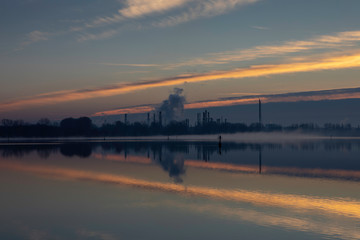 Fototapeta na wymiar Dawn on a lake with industrial background