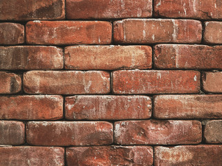 layer of rough red brick wall