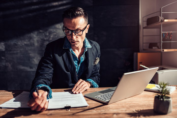 Businessman reading contract in his office