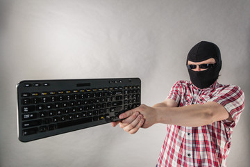 Man wearing balaclava shooting from keyboard