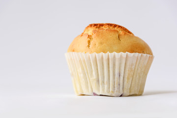 Fresh tasty muffins with berries on white background. Close up. Side view