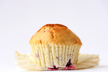 Fresh tasty muffins with berries on white background. Close up. Side view