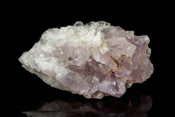 Macro mineral amethyst quartz stone on a black background