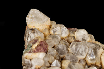 Macro mineral quartz stone with fluorite on granite on a black background