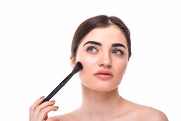 Beauty portrait of a happy beautiful half naked woman holding set of make-up brushes and looking at...