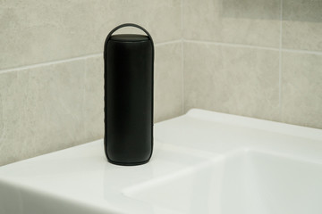 Bluetooth speaker plays music in a bathroom