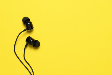 Earbuds on yellow background with text space - 251539898