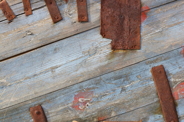 Blue wooden boards and rusty metal stripes as a vintage background